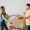 man-and-woman-holding-brown-cardboard-box-4506266